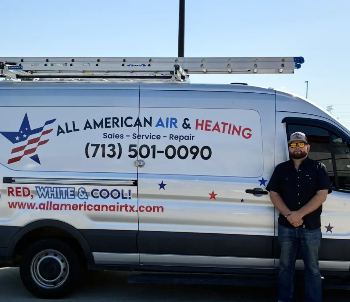 Man standing beside HVAC service van.
